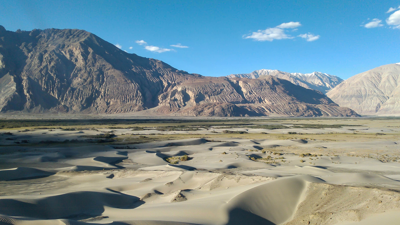 View Of Sand Dunes And Mountain Range At Nubra Valley In Ladakh, India.
